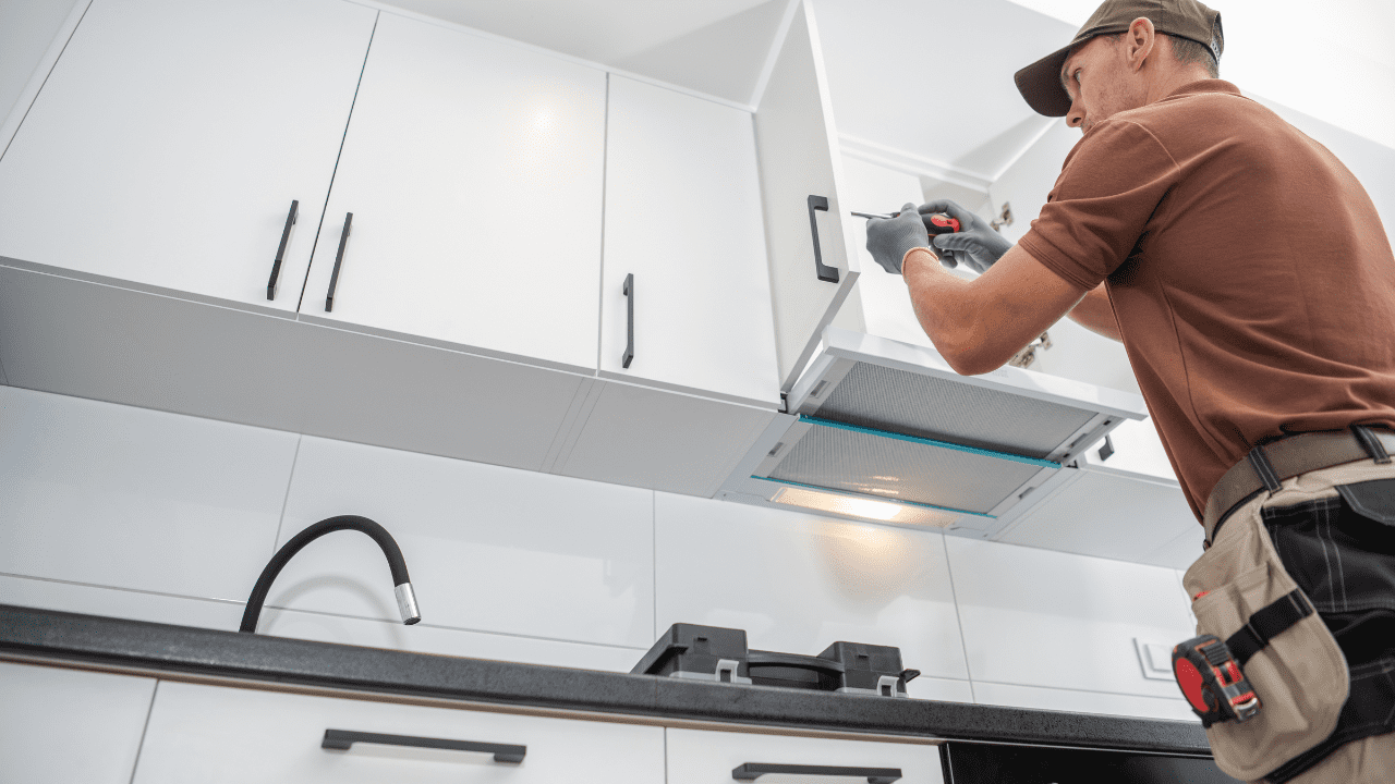 Professional installer setting up Kitchen Cupboards