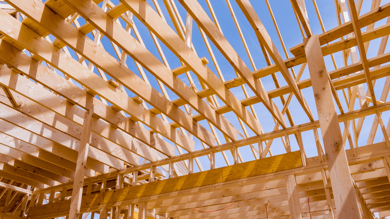 Building timber frame with blue sky background.