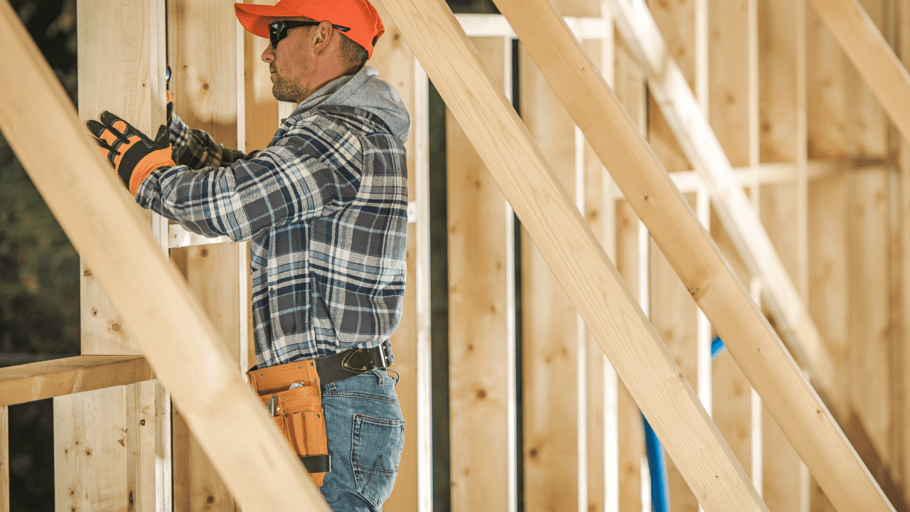 Carpenter building timber frame for a new construction project.