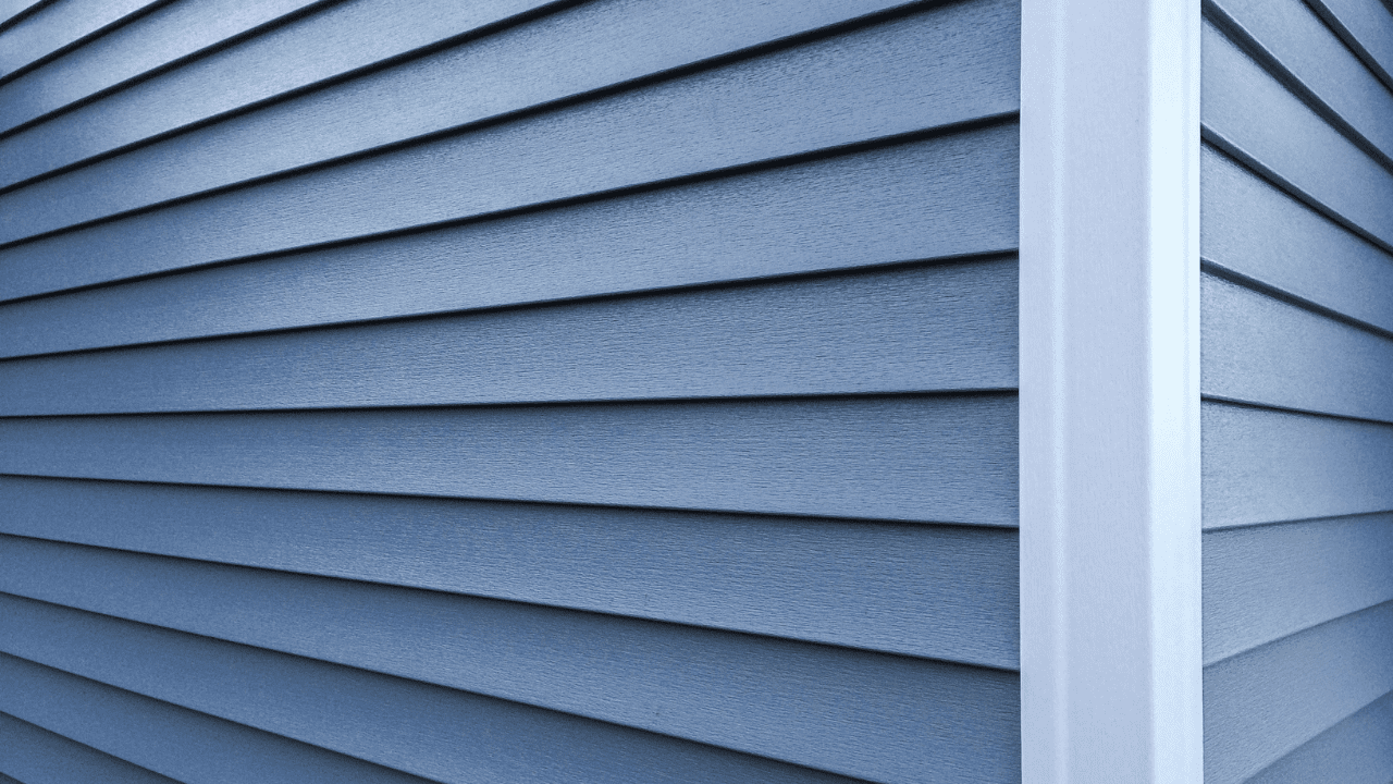 Side of house with blue siding.