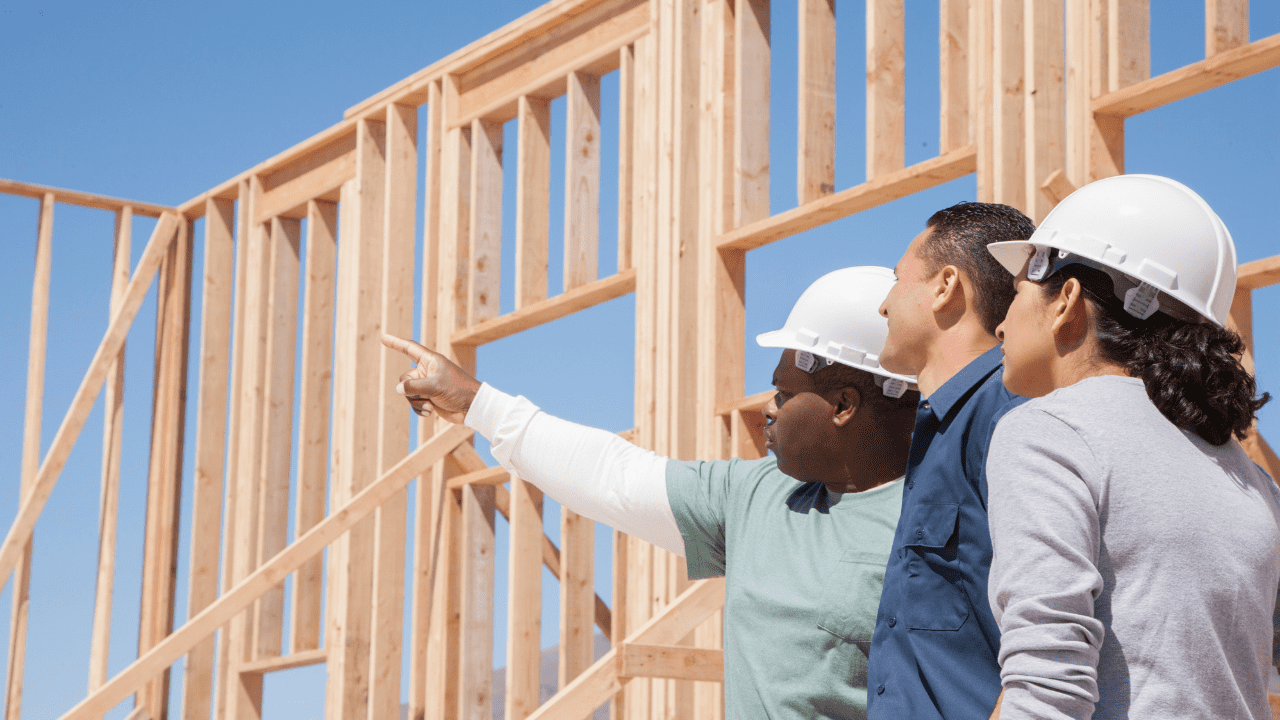 Carpenters and new home owner working together to build a new home.