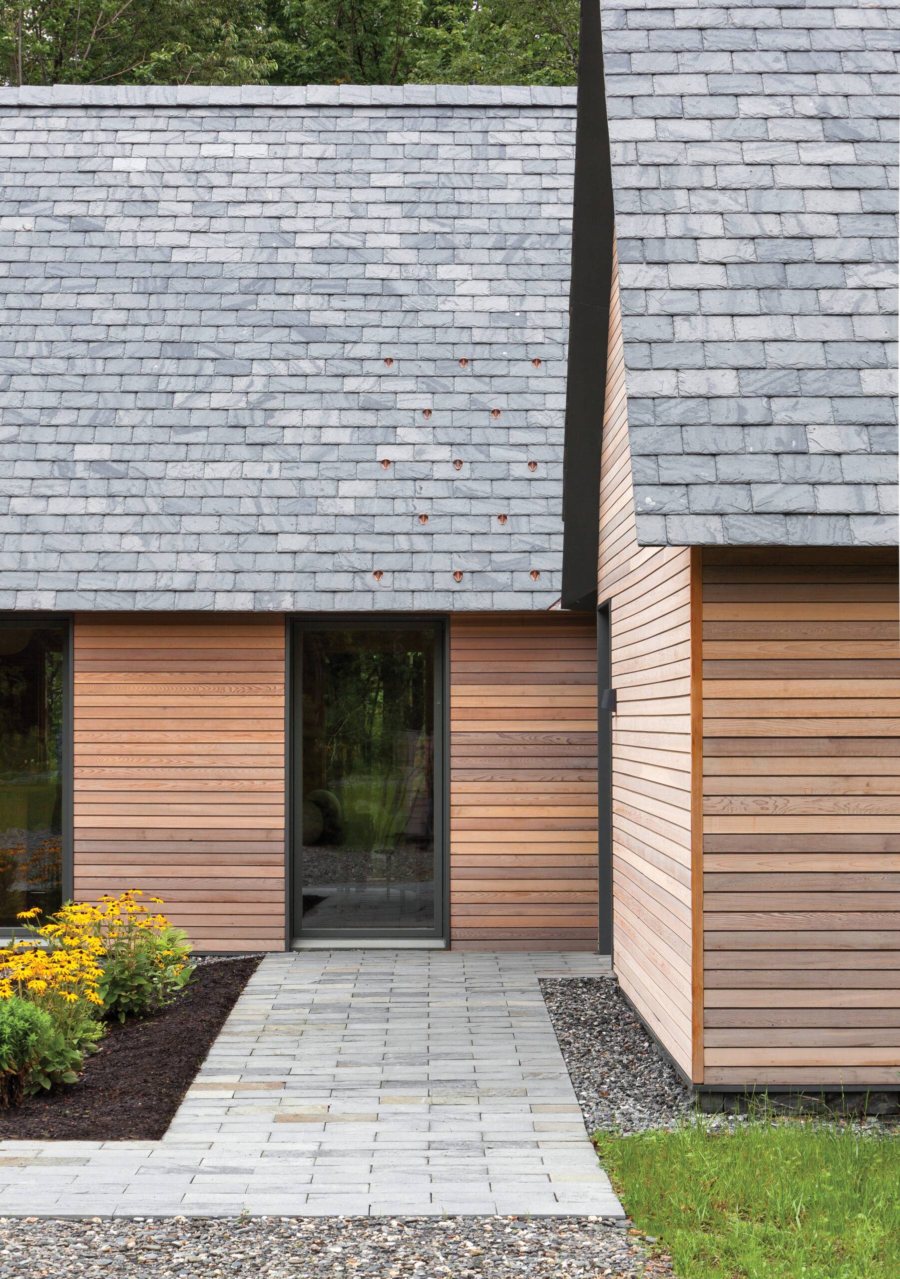 Modern cabin home with sleek black exterior door.