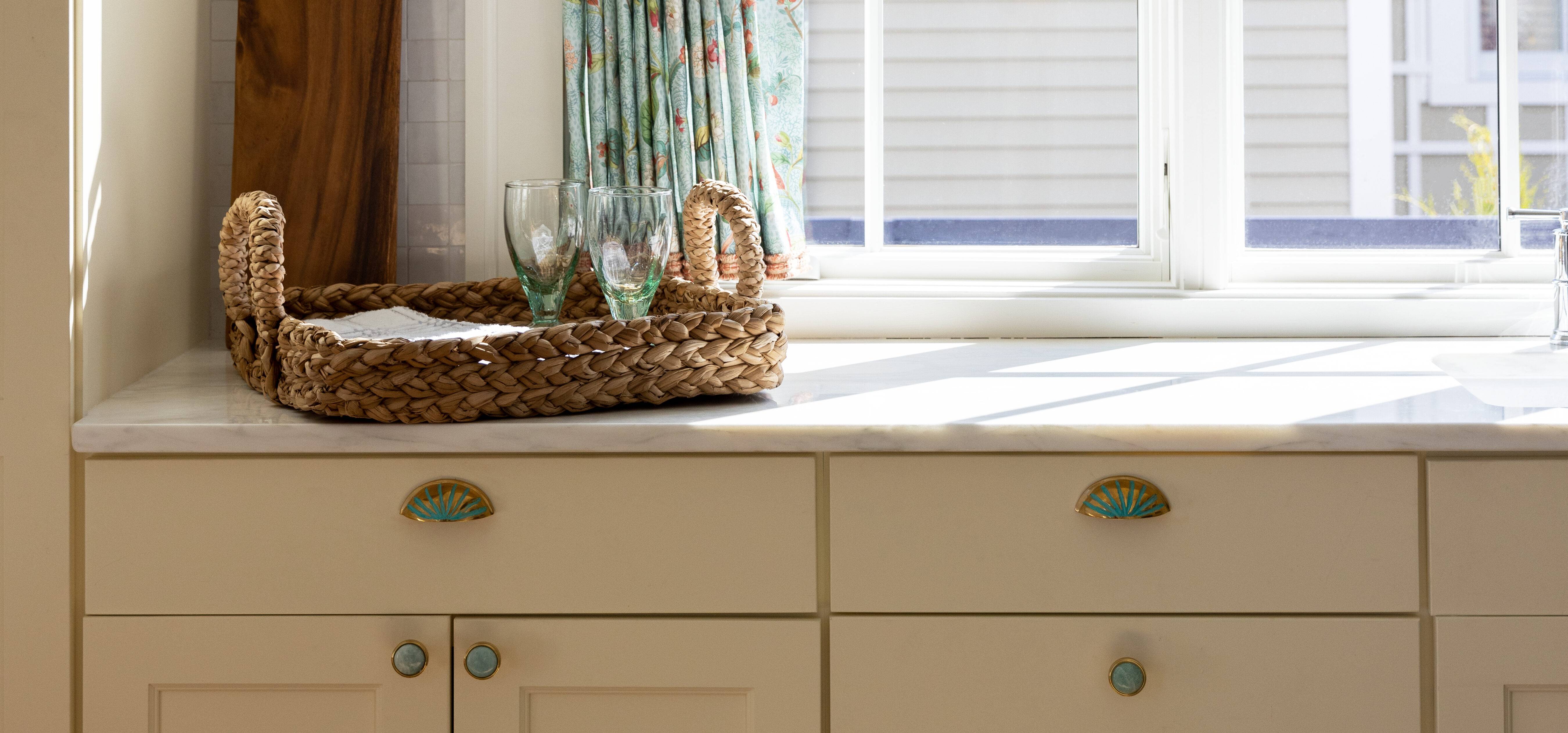 White cabinetry with a beautiful blue knob and matching blue accents